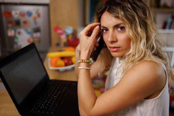 istock Young woman making a business call from home 1396998716