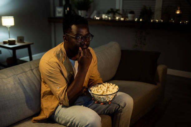 istock Man got scared while watching movie at home 1396999784