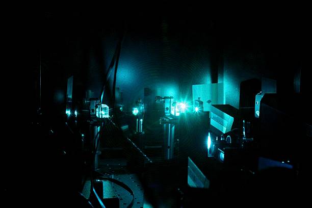 Laser construction The photograph shows part of a construction for scientific research with an Argon laser. The beam travels through several cubes and  diffusers. Please note that this image shows grain at full size. This is the effect of the single coloured laser light on the camera's chip. laserbeam stock pictures, royalty-free photos & images