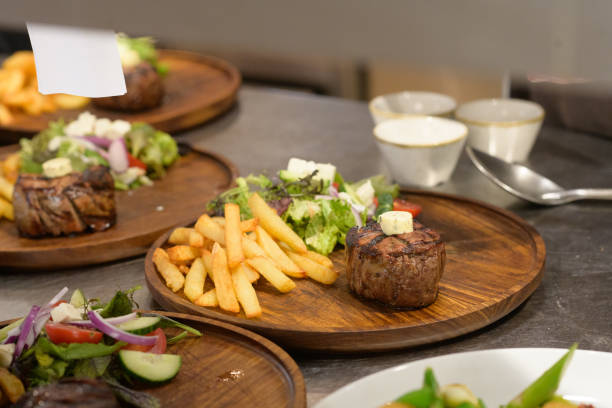 istock Steak Chips and Salad on wooden plate on restaurant kitchen counter 1397001801