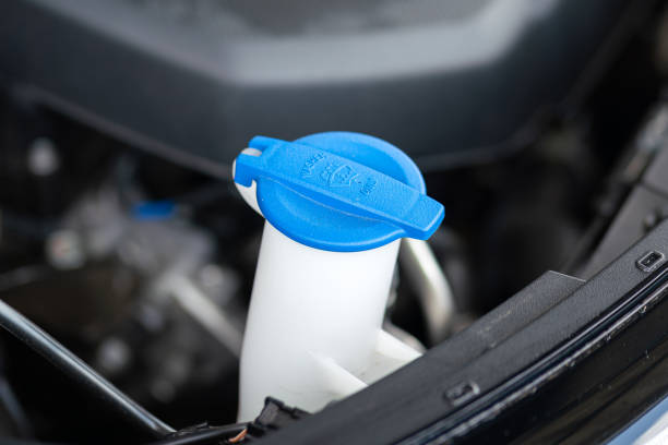 istock A blue plastic bottle cap of car windshield washer water. 1397003453