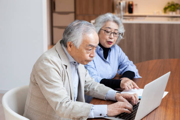 istock Senior couple discuss financial planning while using a laptop. 1397005401