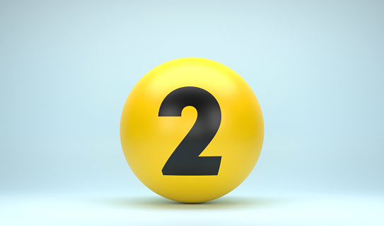 Yellow Sphere With Number 2 On Blue Defocused Background. Number Template
