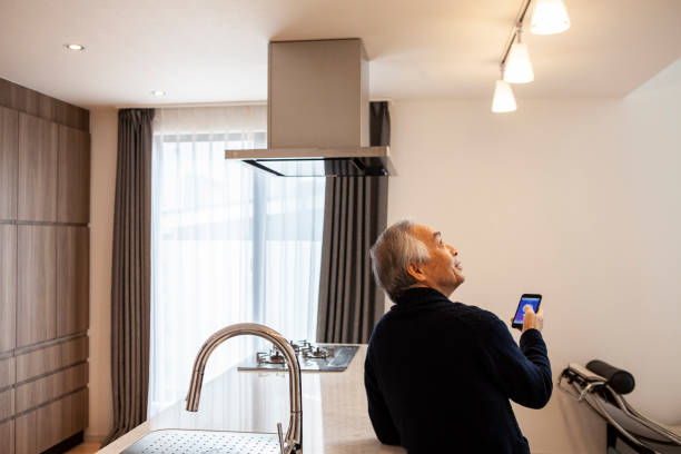istock A senior man turns on lights and electricities by using a digital gadget, smart home appliances 1397007634