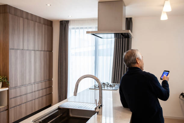 istock A senior man turns on lights and electricities by using a digital gadget, smart home appliances 1397007638