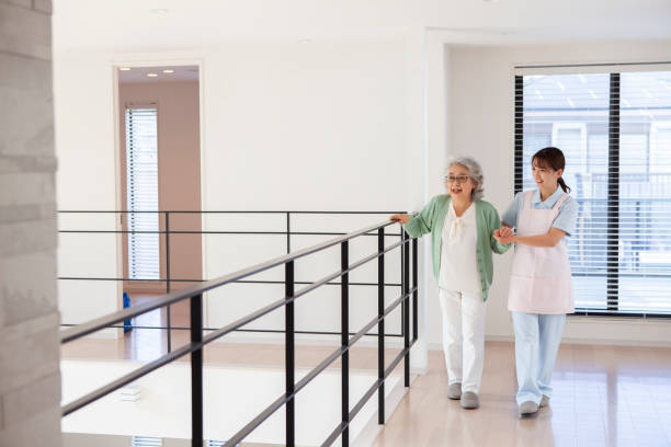 istock Home caregiver  assisting a senior woman walking indoor 1397008607