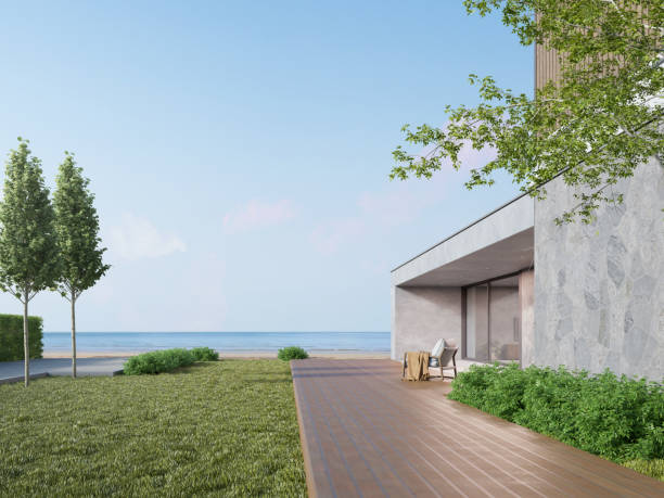 rendering 3d nowoczesnego luksusowego domu z drewnianym tarasem na tle morza. - wood cladding zdjęcia i obrazy z banku zdjęć