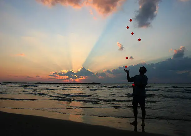 A juggler on the beach.