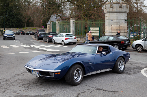 Lamorlaye, France - January 05 2020: Man driving his blue Chevrolet Corvette Stingray.