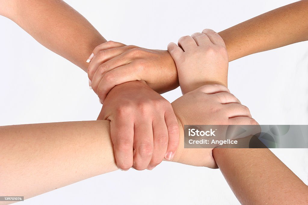 Interlocked hands Interlocked hands of four people Fun Stock Photo