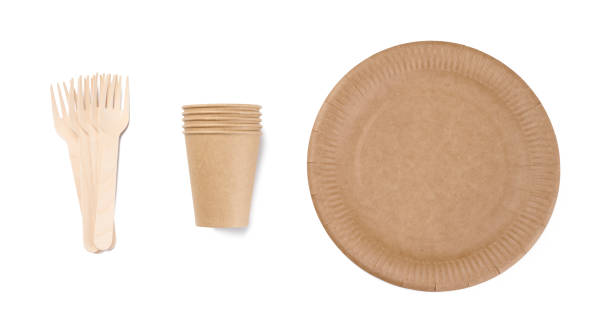 istock Brown paper cups, wooden fork and plates on a white background. Recyclable garbage, rejection of plastic, 1397011421