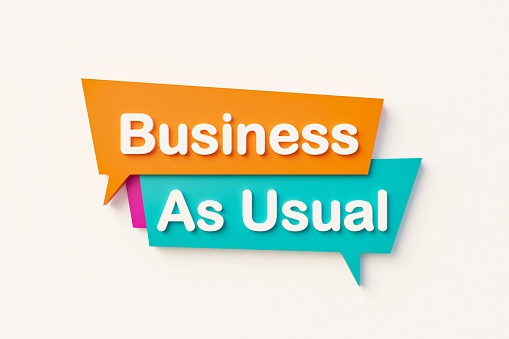 Business as usual. Cartoon speech bubble in orange, blue, purple and white text. Business and encouragement concepts. 3D illustration\