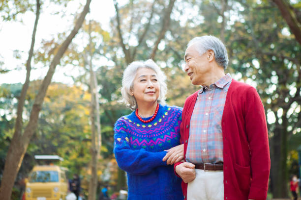 istock A senior couple happily strolling in the park. 1397011660