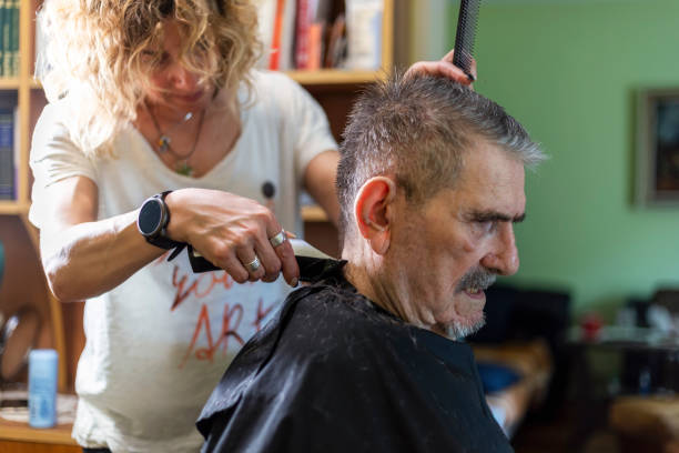 istock Senior man getting hairstyle in nursing home. 1397011868