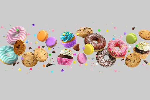 Cakes, sweets, confectionery mix background. Donuts, cookies cupcakes macaroons levitation over light gray background