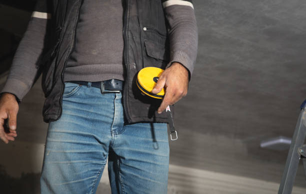 istock Caucasian worker holding measure tape. 1397012482