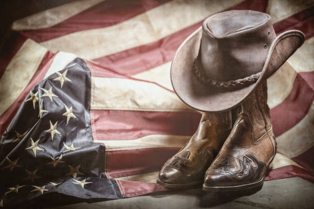 Vintage american flag, cowboy hat and boots, independence or memorial day concept Antique vintage american flag, cowboy hat and boots, independence or memorial day concept usa flag shoes stock pictures, royalty-free photos & images