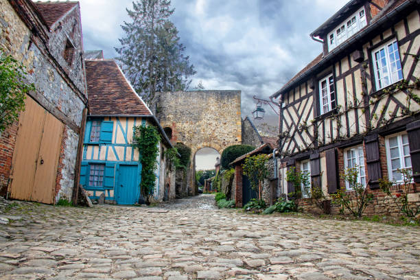 istock Gerberoy, Half-timbered house and the door tower under the threatening sky.Oise. Picardy. Hauts-de-France 1397014396