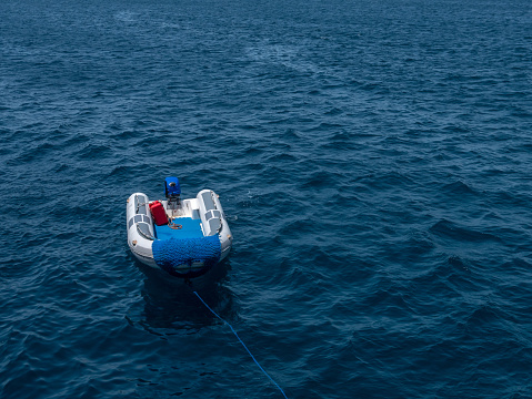 Rubber motor boat Zodiac on the background of the blue sea.