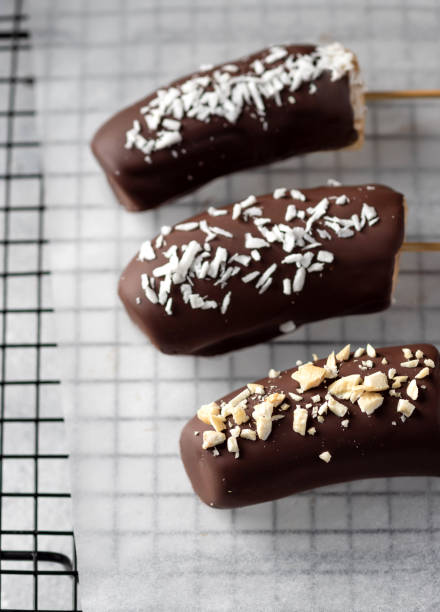 istock Frozen bananas in dark chocolate with nuts and coconut 1397016693