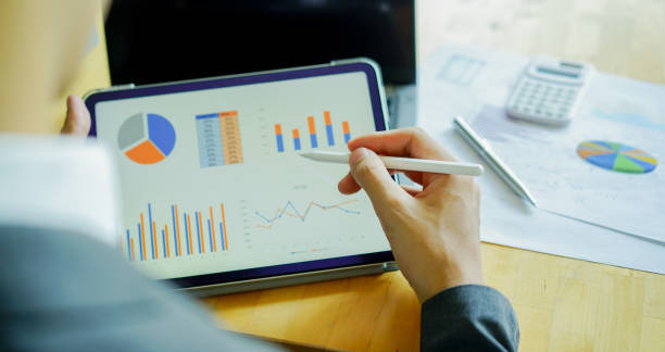istock business man hand hold tablet and use stylus pen to check performance and summary report of company at office board room for business and industry concept 1397016924