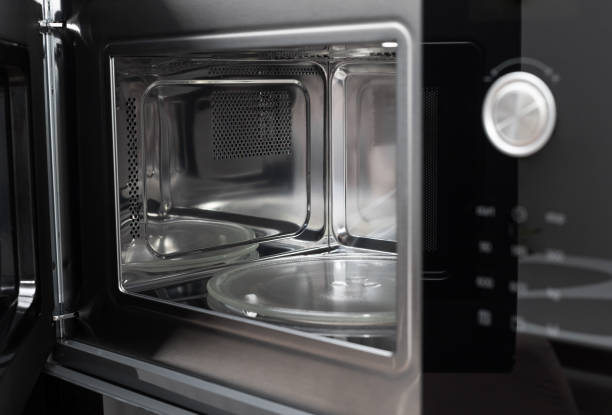 istock Inside view of clean, empty microwave built in kitchen cabinet 1397017062