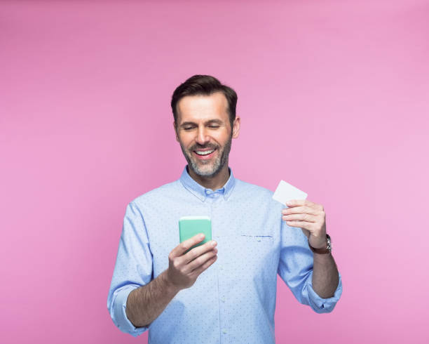 istock Man holding credit card using smart phone 1397017229