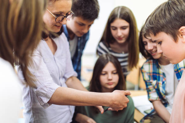 istock Professor and students are researching using phone mobile 1397017245