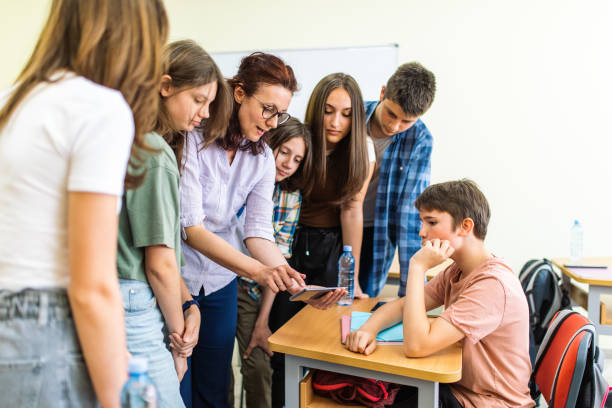 istock Professor and students are researching using phone mobile 1397017266