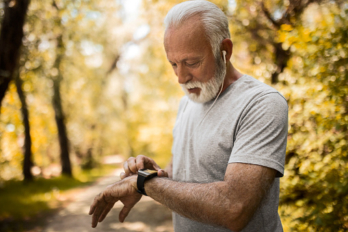 Senior Man using Smart Watch measuring heart rate