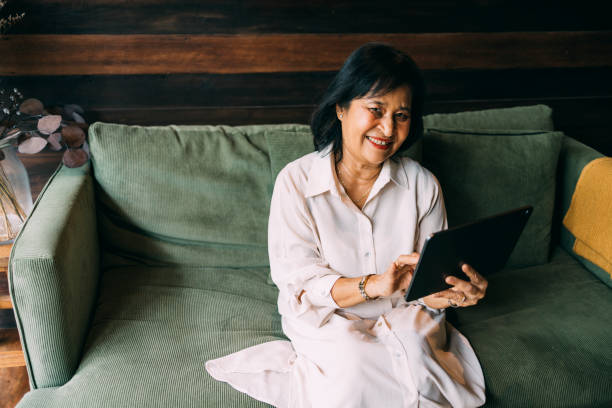 istock Senior Asian Woman Browsing Her Social Media 1397018613