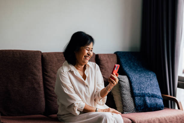 istock Senior Woman Using Her Phone At Home 1397018665
