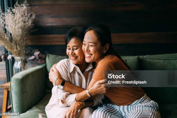 Mother And Daughter Hugging Each Other Stock Photo - Download Image Now - Mother, Senior Adult, Daughter