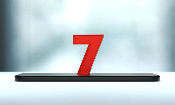 Human crowd forming number seven inside of a human heart shape on white background. Horizontal  composition with copy space.