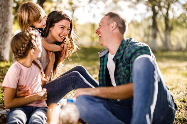 istock Cheerful parents and their small kids having fun during picnic in springtime. 1397020535