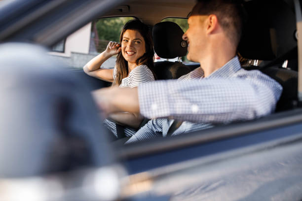 istock Happy couple talking while going on a trip by car. 1397020643