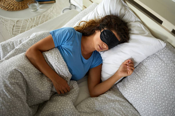 istock Young woman sleeping peacefully in her bed 1397020832