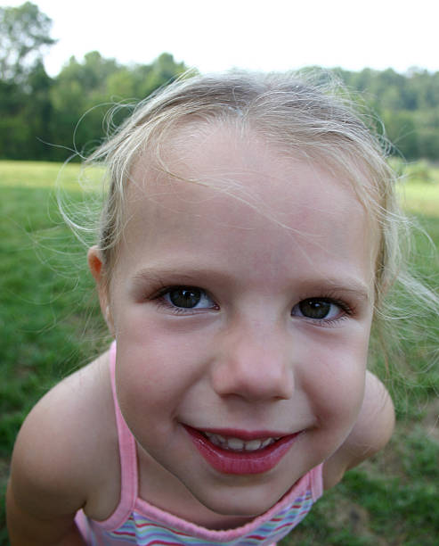 Young girl face smiling close-up stock photo