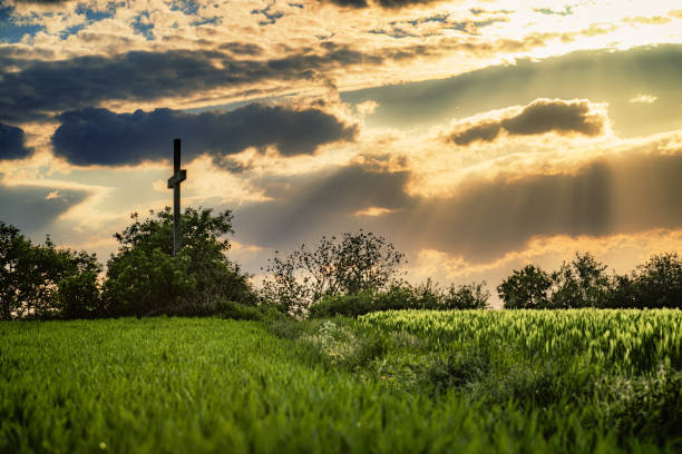 istock Dramatic sunset light on a Cross in coudy evening in Germany, Krefeld 1397021918