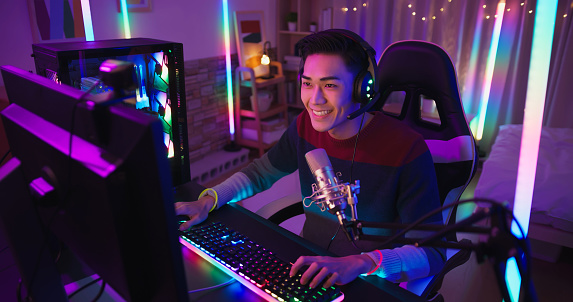 Young Asian Pro Gamer have live stream with fans happily at home