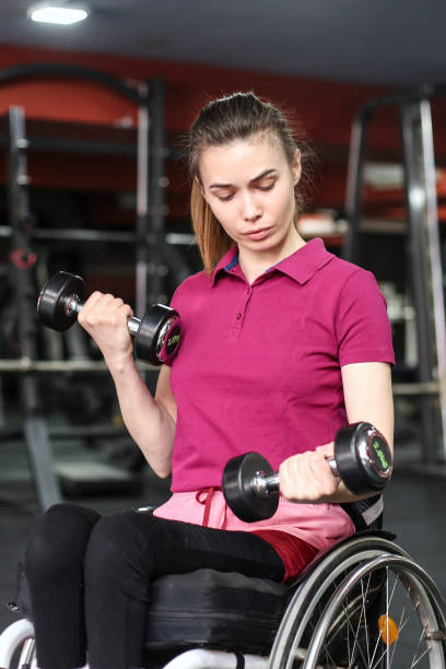 istock Disabled young woman exercising with dumbells 1397022074