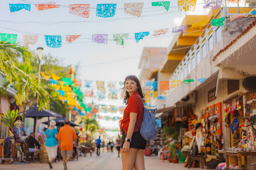 Young Caucasian woman walking on street in Mexico. Cozumel island
