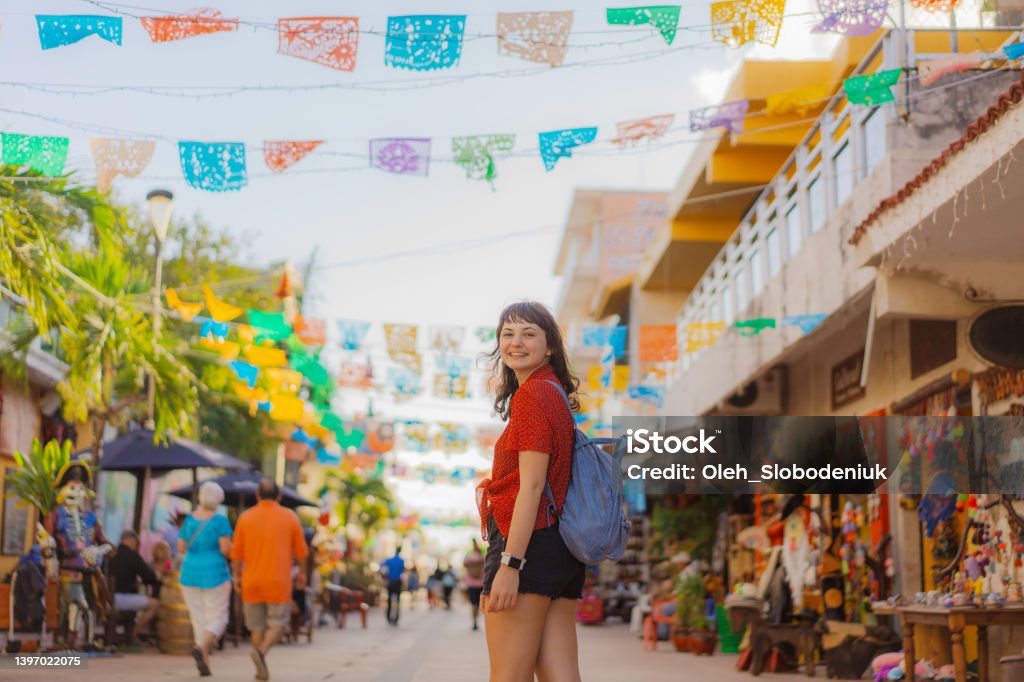 Woman walking on street in Mexico Young Caucasian woman walking on street in Mexico. Cozumel island Mexico Stock Photo