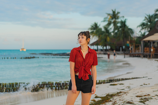 Young Caucasian woman walking on the  of seaside on  Isla Mujeres