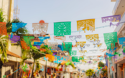 Banderas ondean en la calle de un pequeño pueblo mexicano photo
