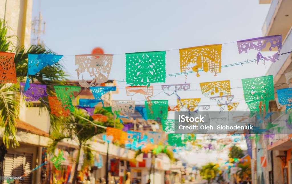 Flags are waving on the street of small Mexican town Colourful flags  are waving on the street of small Mexican town Mexico Stock Photo