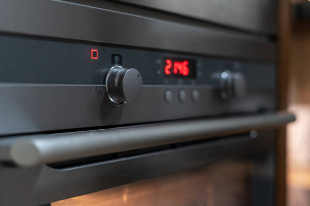 Modern grey oven showing time in digital numbers Closeup of grey oven showing time in digital numbers. Bakery concept. Home comfort. Place for cooking. Household equipment. Modern technology oven door stock pictures, royalty-free photos & images