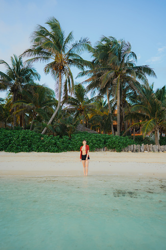 Young Caucasian woman walking on the  of seaside on  Isla Mujeres