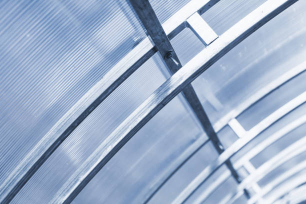Modern greenhouse structure. Double arched reinforced steel frame and polycarbonate roof
