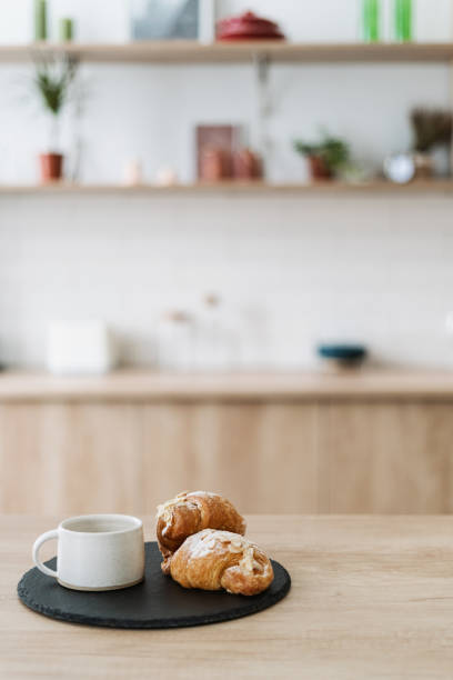 istock Homemade croissant and coffee cup on black plate 1397025344